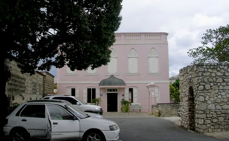 The restored Nidhe Israel Synagogue in Bridgetown, Barbados, with tall shuttered openings and a white rendered masonry facade
