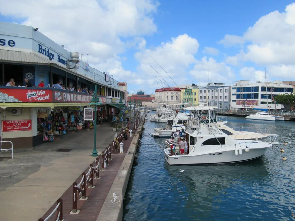 Vessels moored in the Careenage basin in Bridgetown, Barbados, with waterfront buildings behind